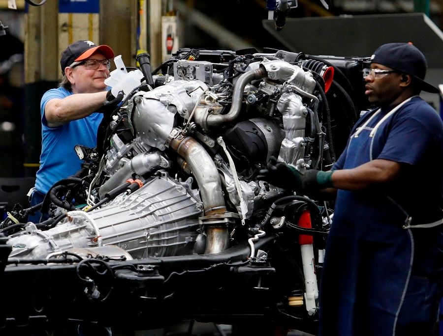 In this file photo taken on 12 June 2019, workers build the chassis of General Motors pickup trucks at the Flint Assembly plant in Flint, Michigan. (Jeff Kowalsky/AFP)