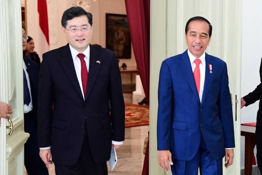 Indonesian President Joko Widodo walks with Chinese Foreign Minister Qin Gang during their meeting in the palace in Jakarta, Indonesia, 22 February 2023. (Indonesia's Presidential Palace/Handout via Reuters)
