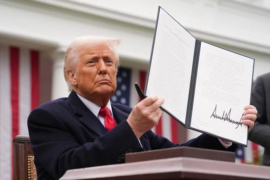 US President Donald Trump displays a signed executive order imposing tariffs on imported goods during a “Make America Wealthy Again” trade announcement event in the Rose Garden at the White House in Washington, DC, on 2 April 2025. (Andrew Harnik/Getty Images North America/AFP)