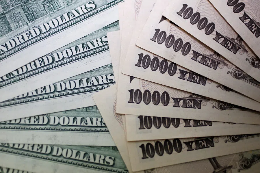 Japanese 10,000 yen notes are spread out next to US 100 dollar bills at Interbank Inc. money exchange in Tokyo, in this picture illustration taken on 9 September 2010. (Yuriko Nakao/Reuters)