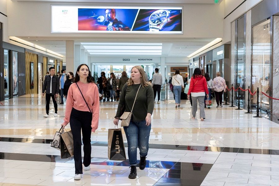 People carrying shopping bags walk inside the King of Prussia shopping mall, as shoppers show up early for the Black Friday sales, in King of Prussia, Pennsylvania, US, 26 November 2021. (Rachel Wisniewski/File Photo/Reuters)