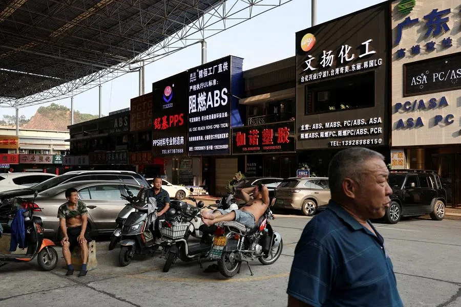 People rest at a parking space in Zhangmutou Town, also known as “Plastic City”, as rising oil prices drive up production costs for plastic manufacturers, in Dongguan, Guangdong province, China, on 1 April 2026. (Go Nakamura/Reuters)