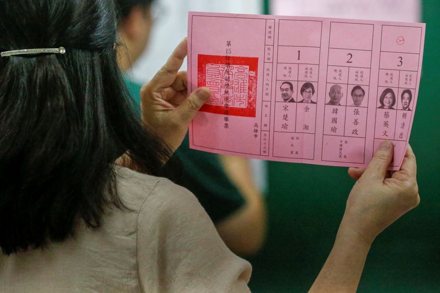 An election official shows a ballot with vote for Taiwan President Tsai Ing-wen as votes are counted at a polling station in Kaohsiung on 11 January 2020. (Ann Wang/Reuters)