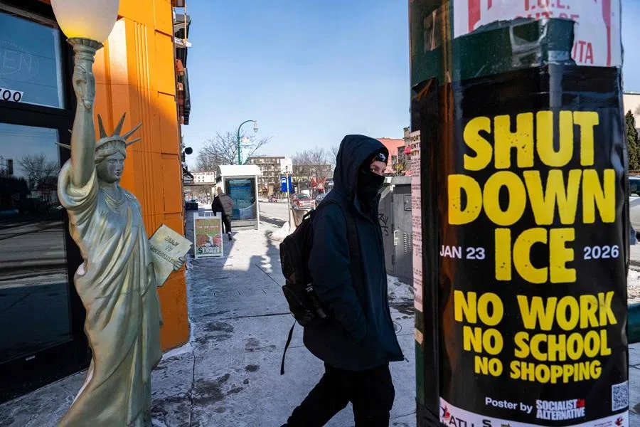 A person walks past a Lady Liberty statue in front of a shuttered gyro shop and a poster calling for a strike of businesses under the banner "ICE out of Minnesota: Day of Truth and Freedom" in Minneapolis, Minnesota, on 23 January 2026. (Roberto Schmidt/AFP)