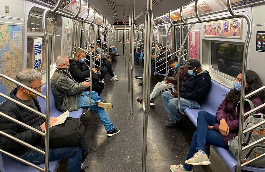 Commuters ride the New York City Subway on 5 November 2020, as the coronavirus pandemic continues worldwide. (Daniel Slim/AFP)