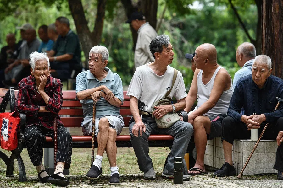 Elderly people rest at a park in Fuyang in eastern China’s Anhui province on 13 September 2024. (AFP)