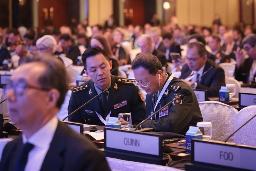 Major General Meng Xiangqing (right), the head of the Chinese official delegation, in discussion with a fellow Chinese delegate at the plenary session on Managing Regional Tensions Amid Global Competition at the Shangri-La Dialogue on 31 May 2026.