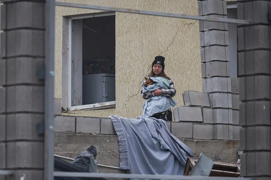 A resident holds a dog next to her house damaged by a Russian missile strike, amid Russia’s attack on Ukraine, on the outskirts of Odesa, Ukraine, on 28 November 2024. (Nina Liashonok/Reuters)