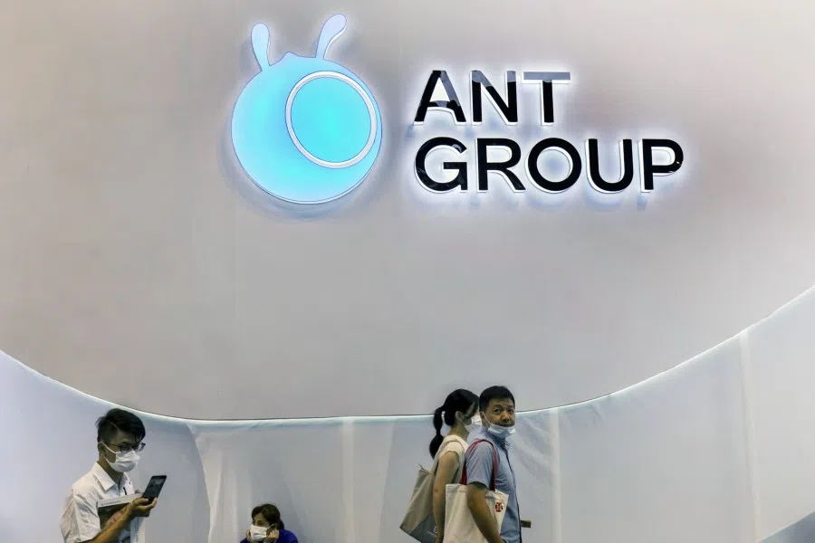 People walk past the Ant Group Co. logo at the World Artificial Intelligence Conference (WAIC) in Shanghai, China, on 8 July 2021. (Qilai Shen/Bloomberg)