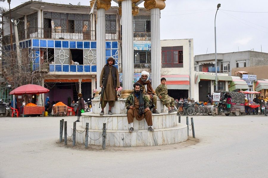 Taliban security personnel sit along a street in Faryab province, Afghanistan, on 10 March 2024. (Atif Aryan/AFP)
