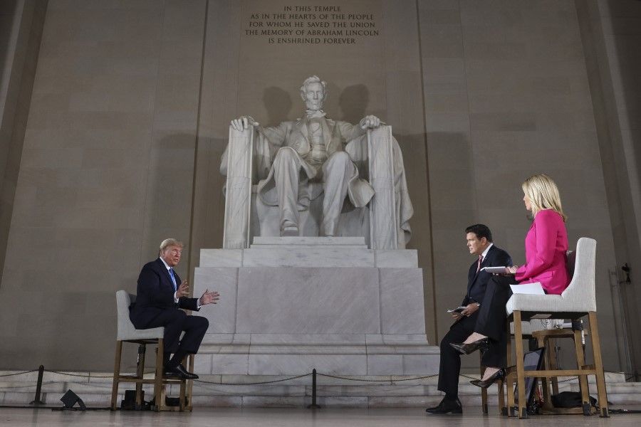 US President Donald Trump (left) speaks during a Fox News town hall at the Lincoln Memorial in Washington, DC, 3 May 2020. (Oliver Contreras/Sipa/Bloomberg)