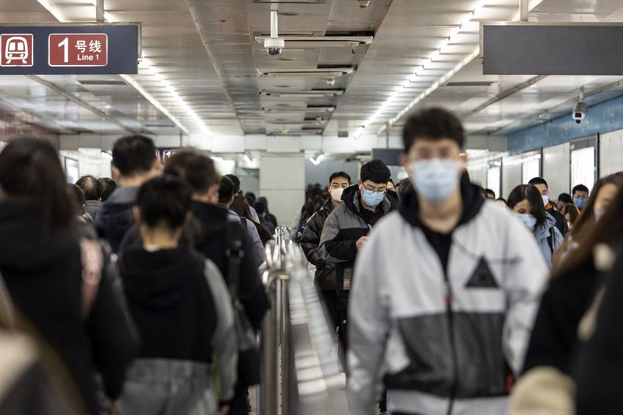 Passengers walk through a subway station in Beijing, China, on 23 November 2021. (Qilai Shen/Bloomberg)