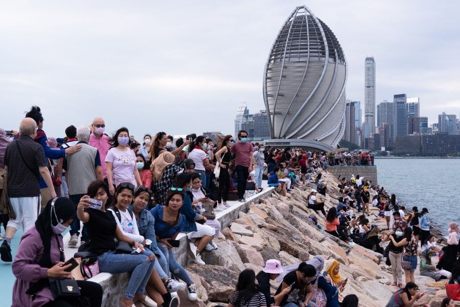 People gather at the newly opened East Coast Park Precinct in Hong Kong on 17 October 2021. (Bertha Wang/AFP)