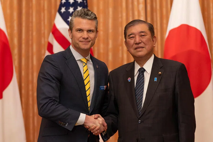 US Secretary of Defense Pete Hegseth (left) shakes hands with Japan’s Prime Minister Shigeru Ishiba during their meeting at the Prime Minister’s office in Tokyo on 30 March 2025. (Stanislav Kogiku/AFP)