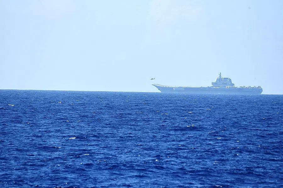 A helicopter takes off from China's Shandong aircraft carrier, over Pacific Ocean waters, south of Okinawa prefecture, Japan, in this handout photo taken on 15 April 2023 and released by the Joint Staff Office of the Defense Ministry of Japan on 17 April 2023. (Joint Staff Office of the Defense Ministry of Japan/Handout via Reuters/File Photo)