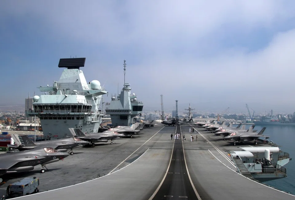 F-35B Lightning II aircraft are seen on the deck of HMS Queen Elizabeth, currently moored at the port of Limassol, Cyprus, 1 July 2021. (Yiannis Kourtoglou/Reuters)