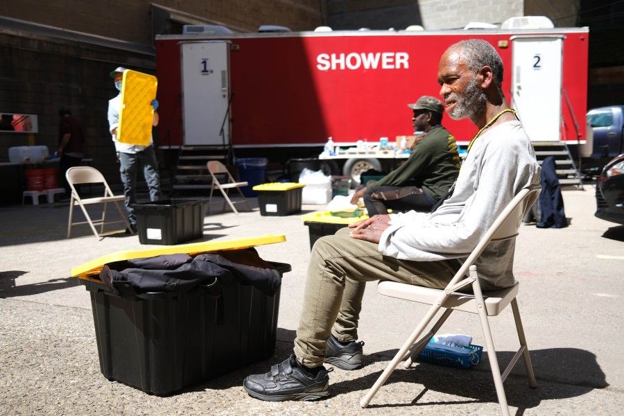 A homeless man waits for a shower to open at a Doctors Without Borders/Médecins Sans Frontières (MSF) temporary shower trailer in Manhattan for the homeless and other vulnerable communities on 7 May 2020 in New York City. Many facilities that service New York's large homeless population have been temporarily closed due to Covid-19. (Spencer Platt/AFP)