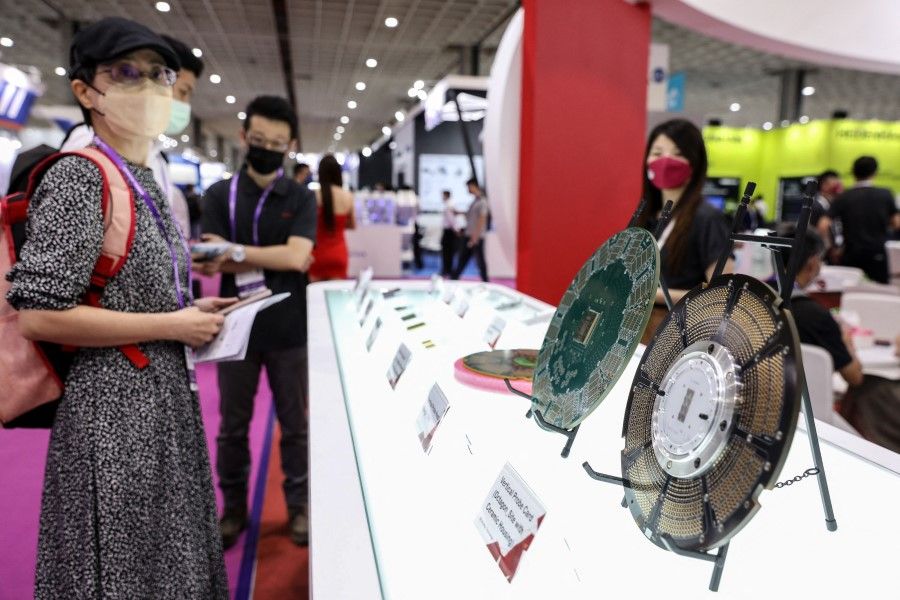 People look at samples of circuit boards on display at SEMICON Taiwan 2022 in Taipei, Taiwan, on 15 September 2022. (I-Hwa Cheng/AFP)