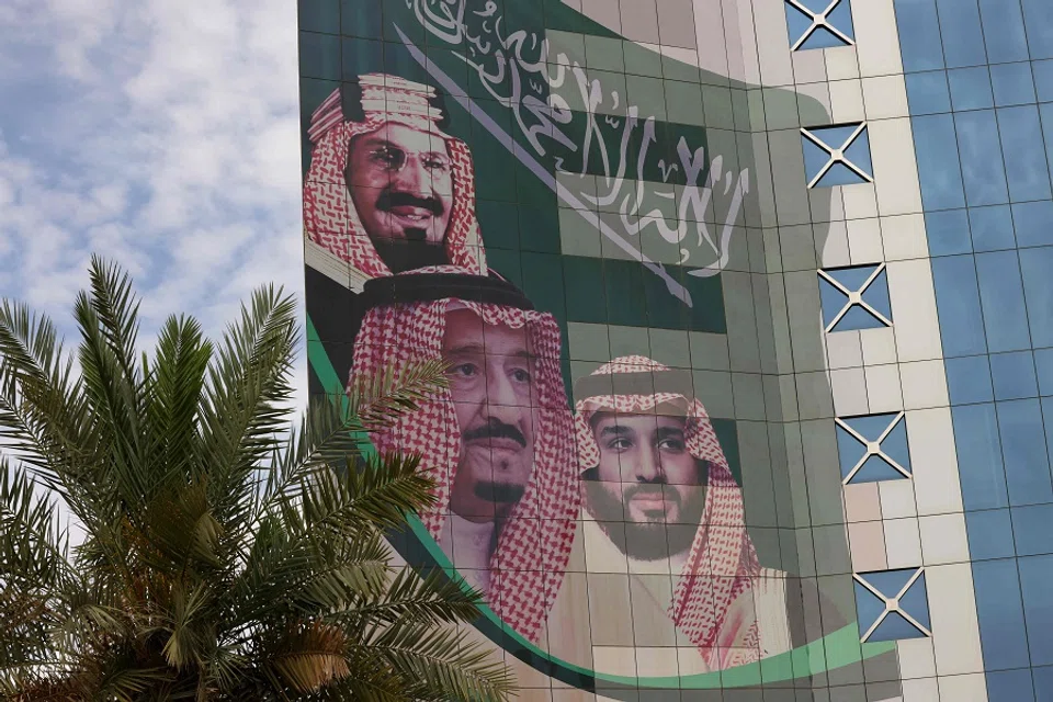 This picture shows a poster depicting King Abdulaziz bin Abdul Rahman Al Saud (left), the founder of the modern Kingdom of Saudi Arabia, King Salman bin Abdulaziz Al Saud (centre), and Crown Prince Mohammed in Riyadh, Saudi Arabia, on 16 April 2023. (Fayez Nureldine/AFP)