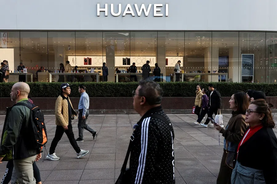 People walk in front of a Huawei store in Shanghai, China, on 28 February 2025.