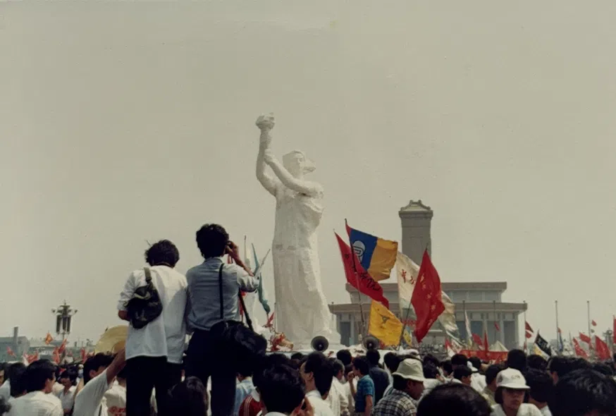 The Goddess of Democracy statue being raised.