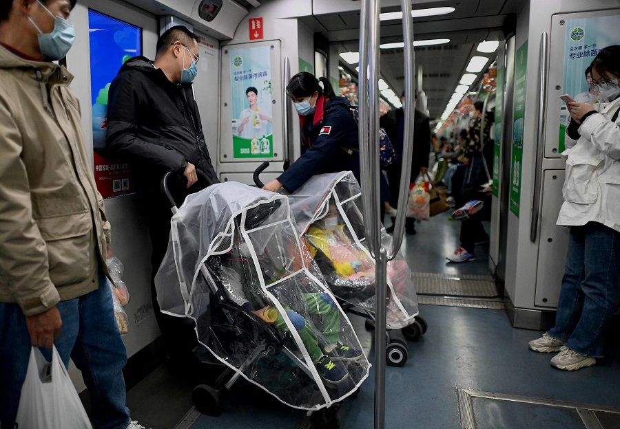 Commuters ride on a subway in Beijing, China, on 16 October 2021. (Noel Celis/AFP)