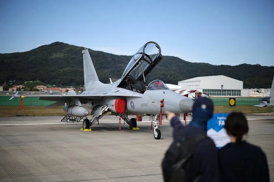 A couple looks at a South Korean FA-50 fighter jet on display during Seoul International Aerospace & Defense Exhibition (ADEX) in Seongnam, South Korea, on 17 October 2025. (Kim Hong-Ji/Reuters)