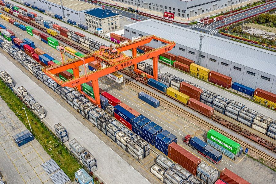 This aerial photo taken on 7 April 2021 shows a crane and containers at a logistic terminal in Nantong, Jiangsu province, China. (STR/AFP)