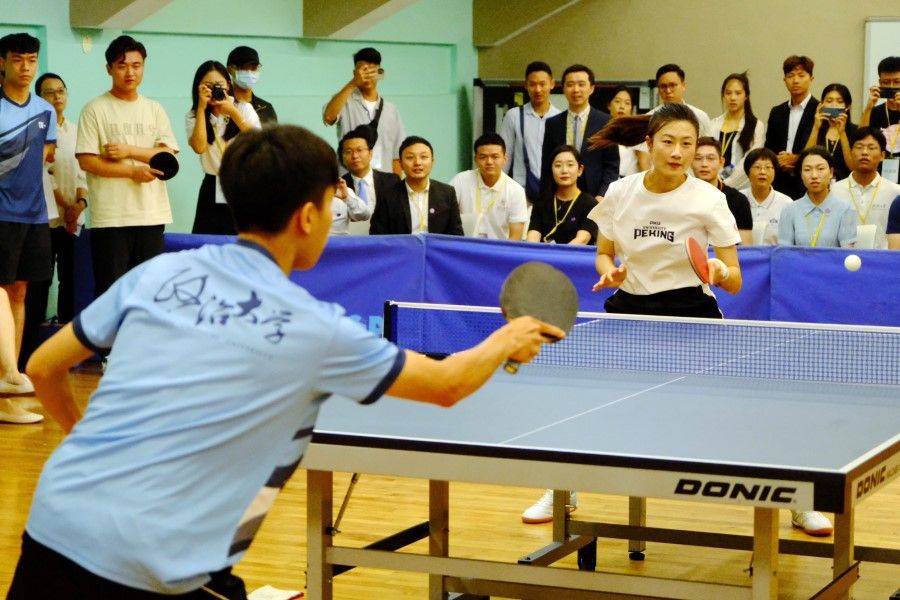 Former Olympic gold medalist Ding Ning in action with a student from National Chengchi University in Taiwan, on 17 July 2023. (CNS)