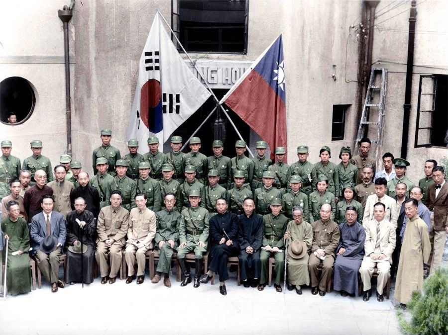 A group photo of Korean and Chinese attendees following the ceremony for the establishment of the Korean Liberation Army (KLA), September 1940. Korean revolutionary leader Kim Gu is in the middle in black; on his left is KLA commander-in-chief Ji Cheong-cheon.