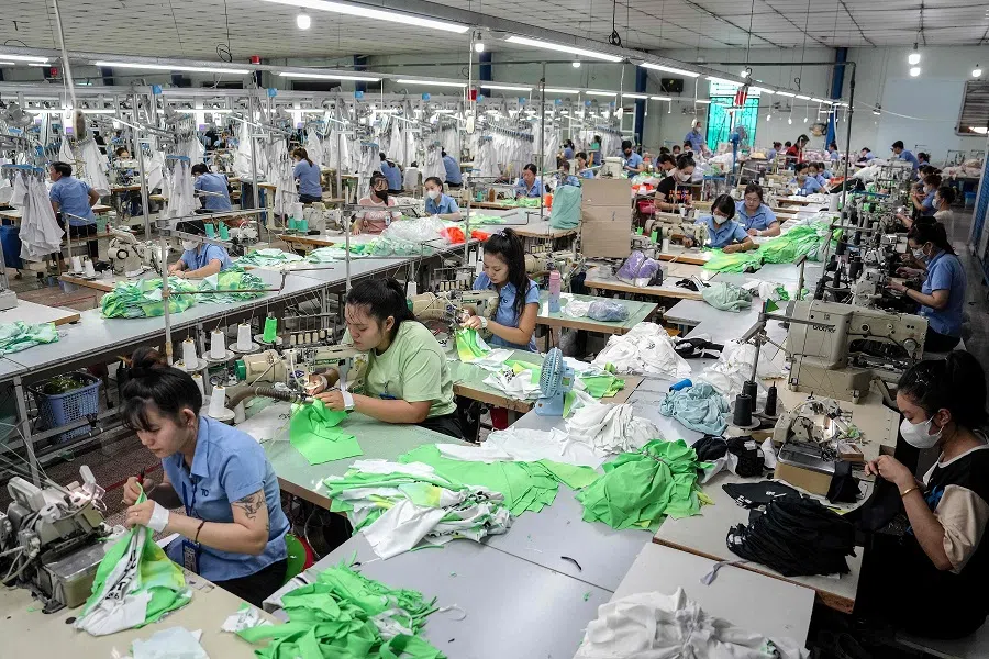 Vietnamese garment factory workers stitch apparel at a factory in Ho Chi Minh City, Vietnam, on 3 April 2025. (Huu Kha/AFP)