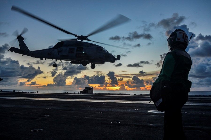 An MH-60R Sea Hawk helicopter launches during flight operations aboard the US Navy aircraft carrier USS Ronald Reagan in the South China Sea, 17 July 2020. (US Navy/Handout via REUTERS)