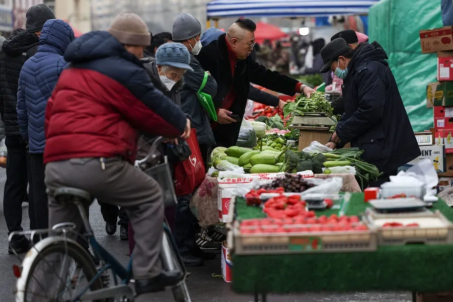 Customers shop for vegetables at a market in Shenyang, Liaoning province, China, on 10 February 2023. (AFP)
