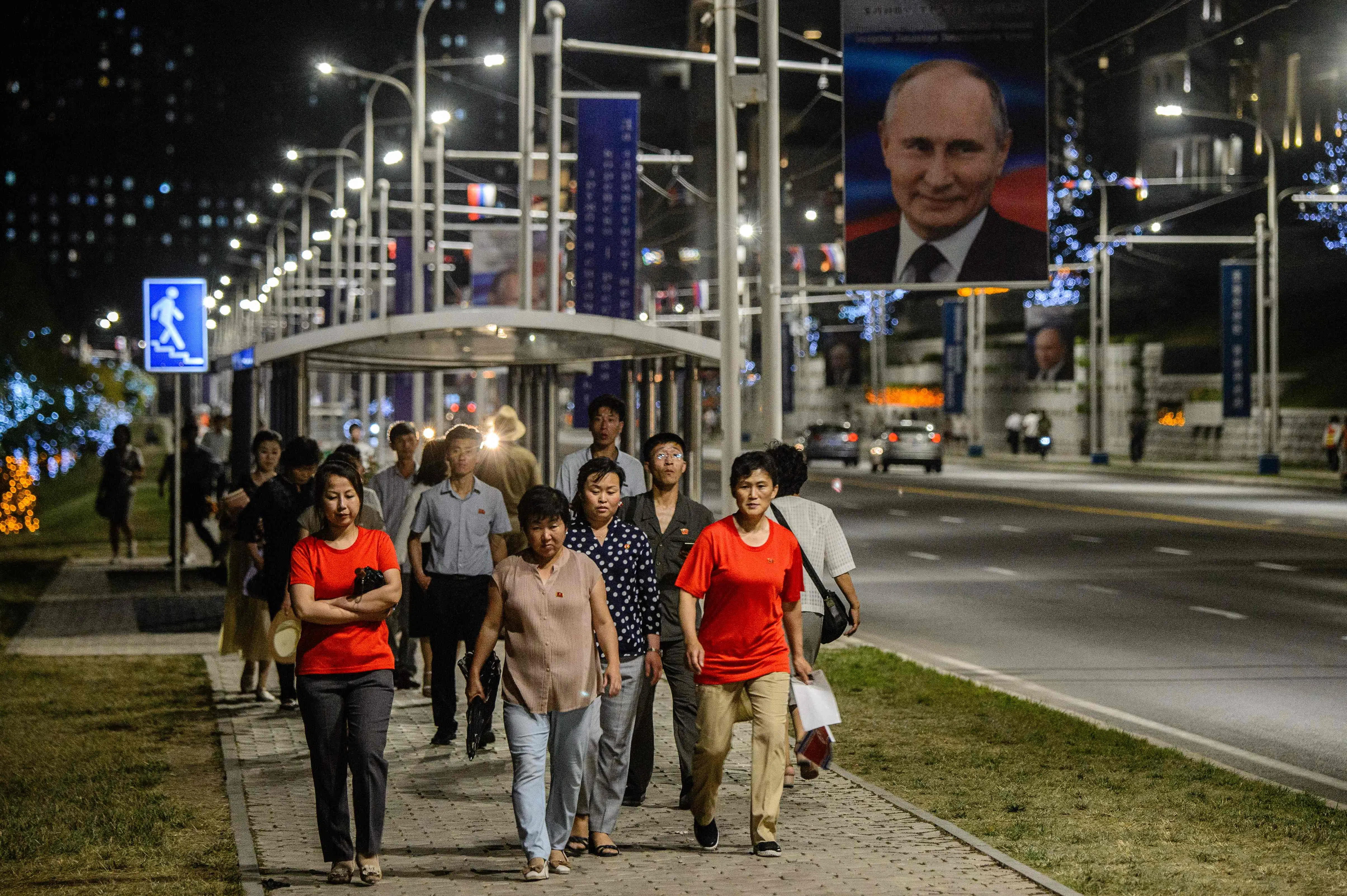 Pedestrians walk along a pavement in Pyongyang on 19 June 2024, during the visit of Russian President Vladimir Putin. (Kim Won Jin/AFP)