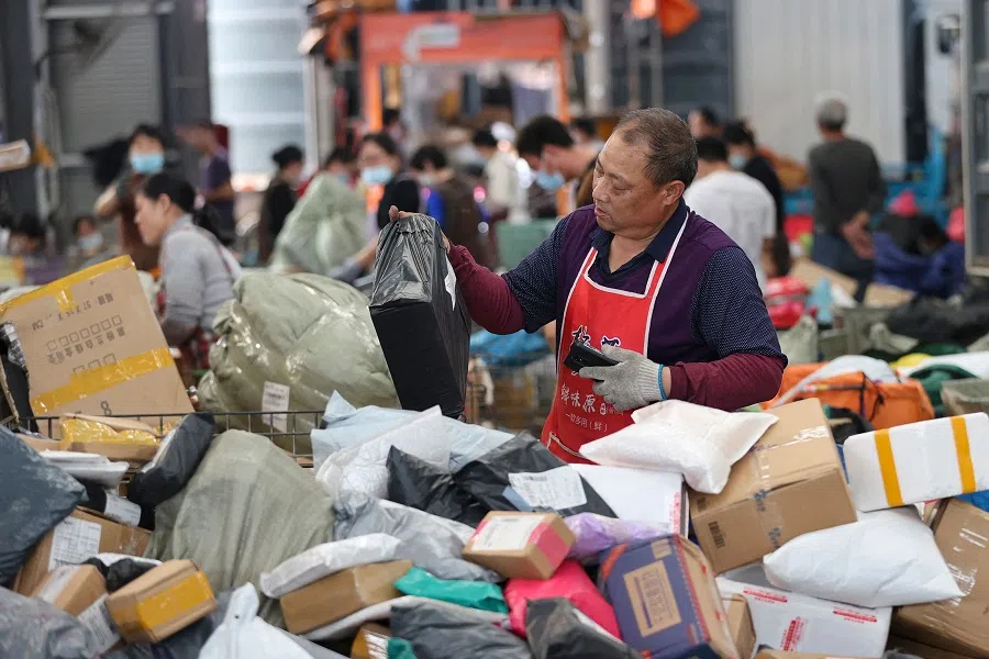 An employee sorts packages for delivery during the Singles' Day shopping festival at a logistics centre in Lianyungang, Jiangsu province, China, on 11 November 2022. (AFP)