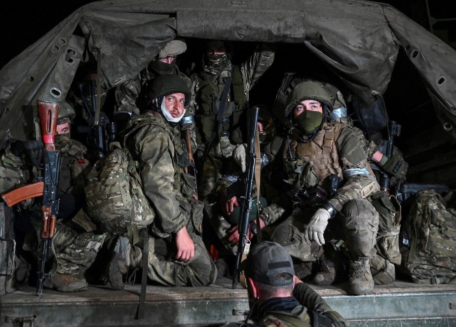 Fighters of Wagner private mercenary group pull out of the headquarters of the Southern Military District to return to base, in the city of Rostov-on-Don, Russia, on 24 June 2023. (Stringer/Reuters)