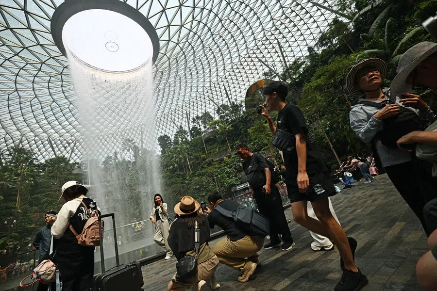 People in front of the Jewel Rain Vortex at Jewel Changi Airport, July 2025. (SPH Media)