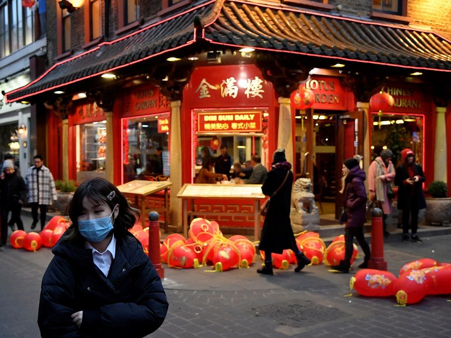 A woman wears a mask in London's Chinatown district, 24 January 2020. (Toby Melville/Reuters)