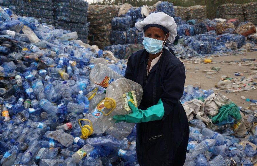 A woman sorts recyclable plastic bottles at a factory in Addis Ababa, Ethiopia, 2 June 2022. (Tiksa Negeri/Reuters)