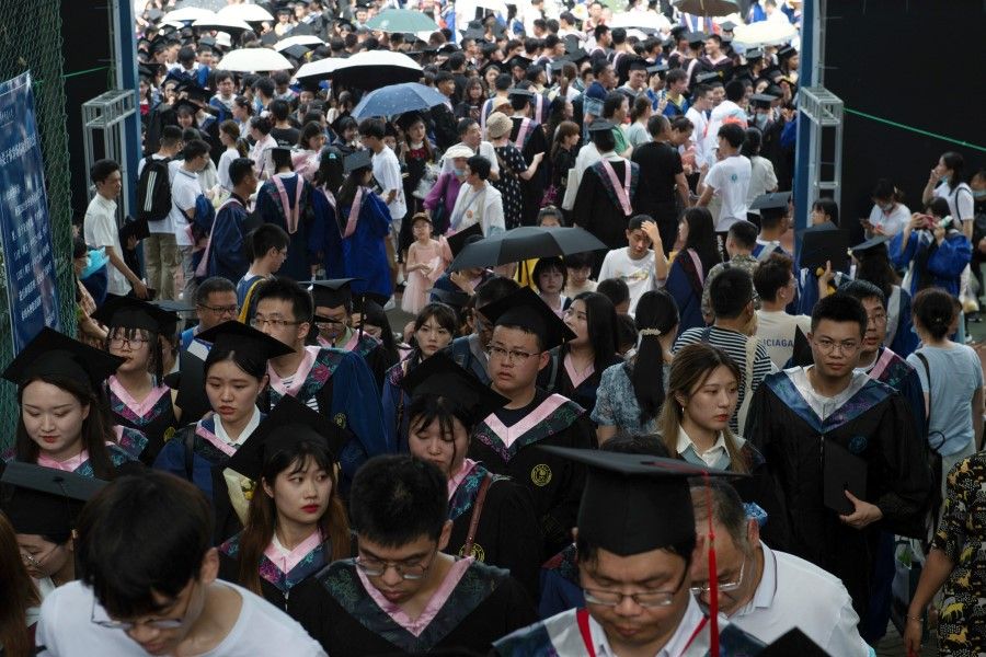 Graduates entering a graduation ceremony at Central China Normal University in Wuhan, Hubei province, China, 13 June 2021. (Stringer/Reuters)