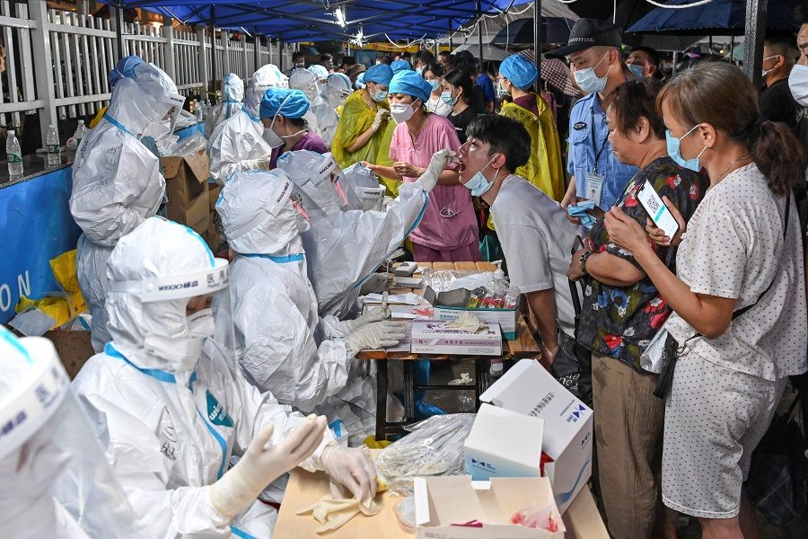 A medical worker collects a swab from a resident during a mass testing for the Covid-19 coronavirus disease at a makeshift testing site in Guangzhou, Guangdong province, China, 30 May 2021. (CNS photo via Reuters)