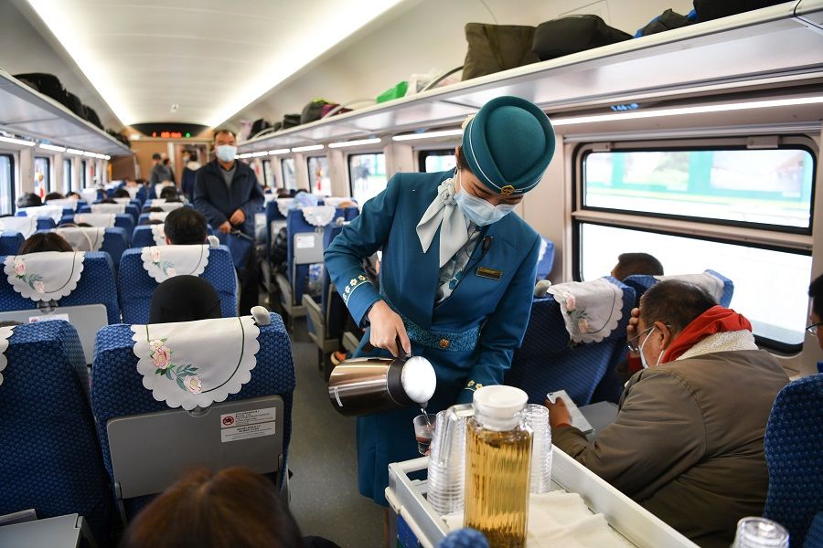 This photo taken on 3 December 2021 shows passengers and train conductors on board the China-Laos railway leaving Kunming Railway Station, Yunnan province, China. (CNS)