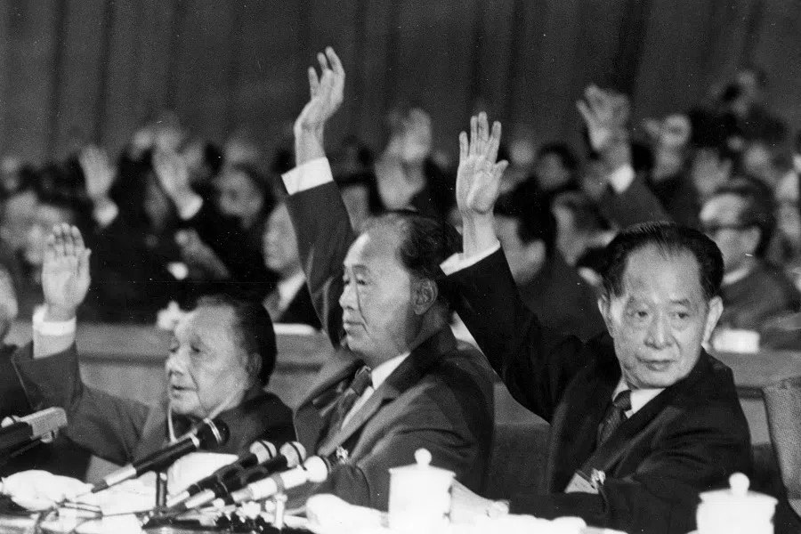 Chinese leaders Deng Xiaoping (left), Zhao Ziyang (centre) and Hu Yaobang (right) raise their hands to vote at the closing session of the Chinese Communist Party's 13th Party Congress in 1987. (CNS)