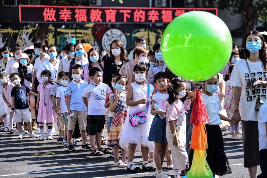 First-year pupils arrive at a primary school for the new semester in Shenyang in China's northeastern Liaoning province on 30 August 2021. (STR/AFP)