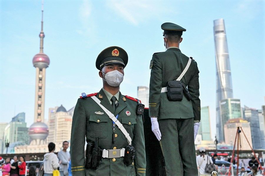 Chinese paramilitary police stand guard on the Bund in the Huangpu district in Shanghai, China, on 10 April 2023. (Hector Retamal/AFP)