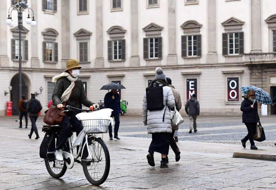 Difficulties in the mainland no longer stay within China as the Covid-19 epidemic sweeps the world. In this photo taken on 2 March 2020, a woman wearing a protective mask is seen crossing Piazza Duomo with her bicycle in Milan. (Miguel Medina/AFP)