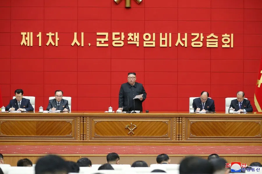 This picture taken on 3 March 2021 and released from North Korea's official Korean Central News Agency (KCNA) on March 4 shows North Korean leader Kim Jong-un (centre) speaking at the conference hall of the office building of the Central Committee of the Workers' Party of Korea (WPK) in Pyongyang. (STR/KCNA via KNS/AFP)