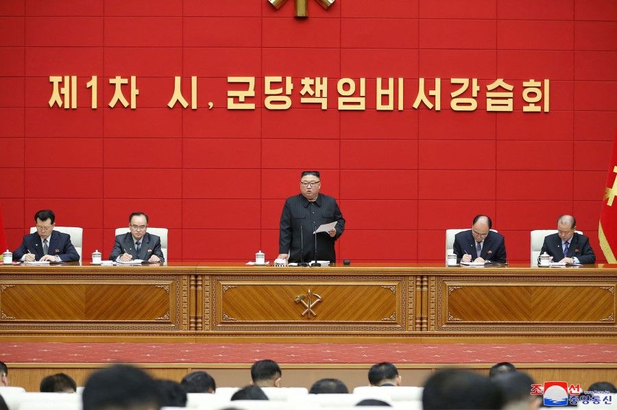 This picture taken on 3 March 2021 and released from North Korea's official Korean Central News Agency (KCNA) on March 4 shows North Korean leader Kim Jong-un (centre) speaking at the conference hall of the office building of the Central Committee of the Workers' Party of Korea (WPK) in Pyongyang. (STR/KCNA via KNS/AFP)