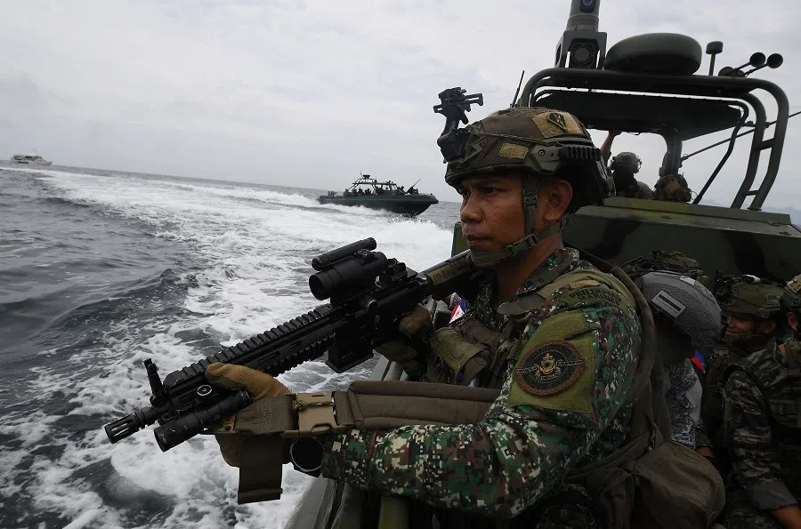 A Philippine marine aboard their patrol boat stand guard during a joint visit, board and seizure (VBS) exercise with their US and South Korean counterparts with members of Japan’s self-defence forces as observers, at the marines training base in Ternate town, Cavite province, west of Manila, Philippines, on 22 October 2024, as part of the annual Philippines-US joint marines exercise dubbed Kamandag (Venom). (Ted Aljibe/AFP)