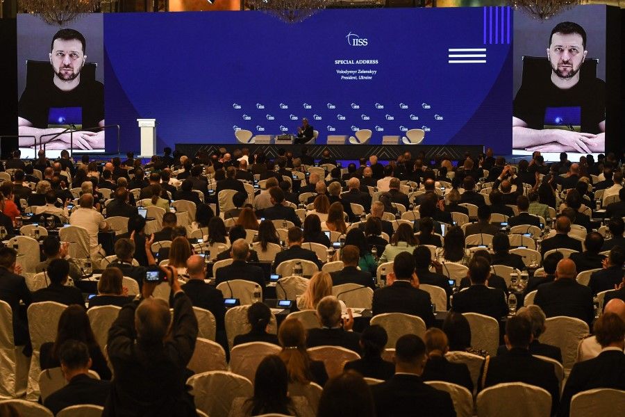 Ukraine's President Volodymyr Zelenskyy (on screen) addresses participants at the Shangri-La Dialogue summit virtually via a video link in Singapore on 11 June 2022. (Roslan Rahman/AFP)